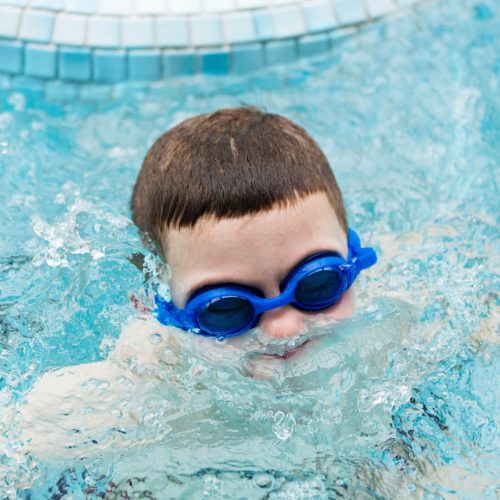 kid-in-a-swimming-pool-surfacing-out-of-water